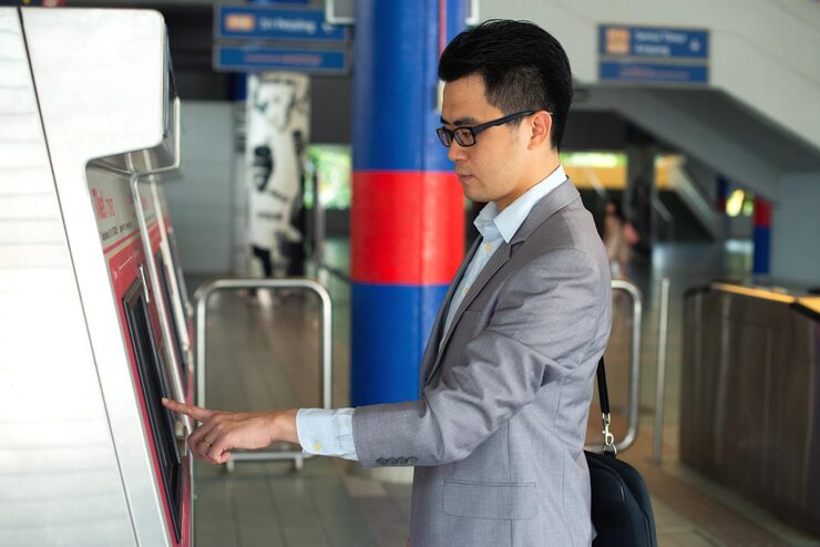 side-view-businessman-using-kiosk-station_1048944-17067064