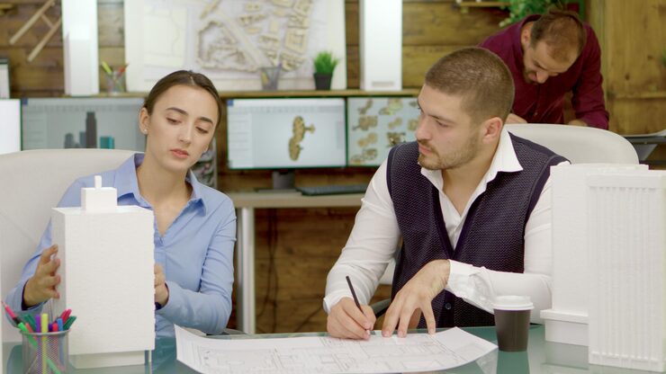 young-talented-architects-changing-plans-business-buildings-architect-drawing-blue-prints_482257-27762